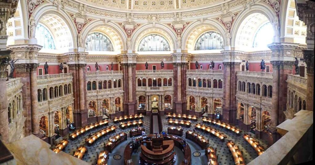The grand interior of the Thomas Jefferson Building, with intricate murals and arches.