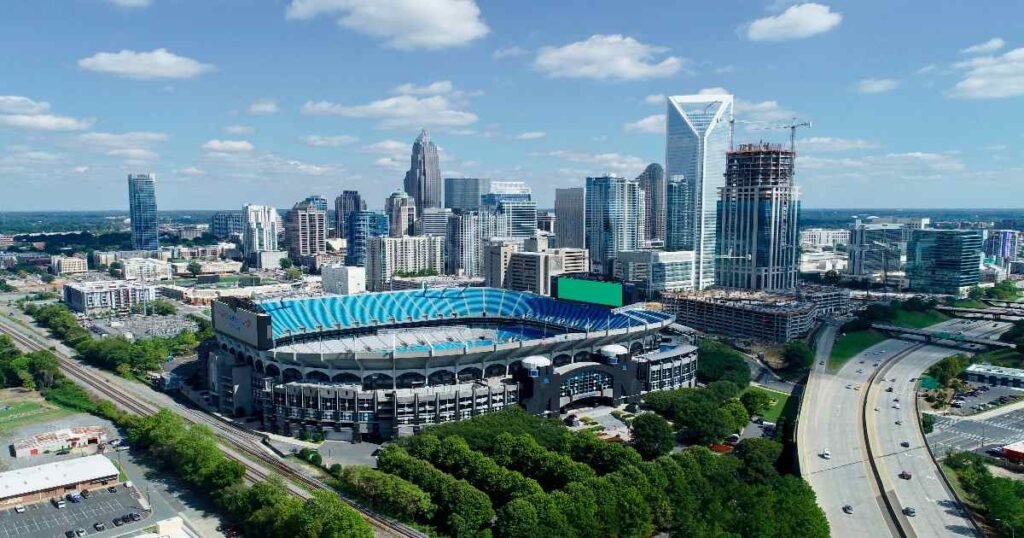 The Charlotte skyline at day, with modern skyscrapers reflecting city lights.