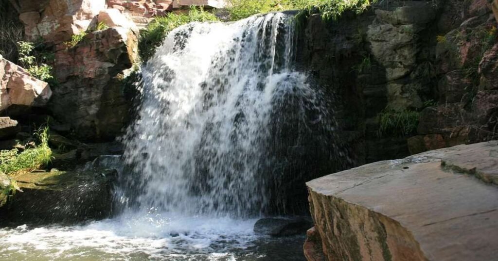 Winnewissa Falls cascading over rock formations at Pipestone National Monument.